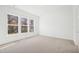 Sun-filled bedroom with neutral carpet and windows framing scenic outside views at 2209 Abbeyhill Dr # 118, Raleigh, NC 27610
