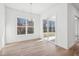 Bright dining room features hardwood floors, large windows, and sliding door to outdoor space at 2209 Abbeyhill Dr # 118, Raleigh, NC 27610