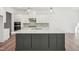 Modern kitchen with gray island, white cabinets, stainless steel appliances, and hardwood floors at 2209 Abbeyhill Dr # 118, Raleigh, NC 27610