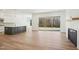 Bright and airy living room with hardwood floors, fireplace, and view to outdoor landscape at 2209 Abbeyhill Dr # 118, Raleigh, NC 27610