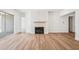 Open living room with hardwood floors, fireplace, and ample natural light at 2209 Abbeyhill Dr # 118, Raleigh, NC 27610