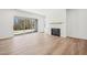 Bright living room featuring a modern fireplace, wood floors, and large sliding doors to the outdoor space at 2209 Abbeyhill Dr # 118, Raleigh, NC 27610