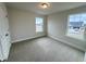 Bedroom featuring neutral walls, carpet, and a window with views of the neighborhood at 224 Bering Cir, Angier, NC 27501