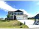 Two-story home featuring a three-car garage, well-manicured lawn, and a charming dark grey and beige exterior at 224 Bering Cir, Angier, NC 27501