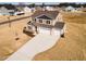 Aerial view of a two-story home with a three-car garage, spacious yard, and beige siding and dark brown roof at 224 Bering Cir, Angier, NC 27501
