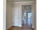 Hallway with white trim, hardwood floors, and neutral walls leading to a bright living space at 224 Bering Cir, Angier, NC 27501