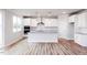 Bright kitchen featuring white cabinets, granite countertops, stainless steel appliances, and hardwood floors at 224 Bering Cir, Angier, NC 27501