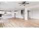 Open-concept living space featuring hardwood floors, and a kitchen and staircase with white cabinets and neutral walls at 224 Bering Cir, Angier, NC 27501