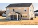 Well-maintained rear exterior with a screened porch and neutral siding at 224 Bering Cir, Angier, NC 27501