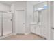Well-lit bathroom featuring a glass shower, a vanity and white cabinets at 32 Boyce Ct, Sanford, NC 27332