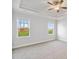 A carpeted bedroom offers two windows with views of the outside at 32 Boyce Ct, Sanford, NC 27332