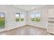 Dining area features wainscotting, luxury vinyl plank flooring, and a view to the rear yard at 32 Boyce Ct, Sanford, NC 27332