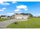 Charming home featuring a three-car garage, stone accents, well manicured lawn, and a large driveway at 32 Boyce Ct, Sanford, NC 27332
