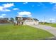 Charming home featuring a three-car garage, stone accents, well manicured lawn, and a large driveway at 32 Boyce Ct, Sanford, NC 27332