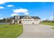 Charming home featuring a three-car garage, stone accents, well manicured lawn, and a large driveway at 32 Boyce Ct, Sanford, NC 27332