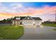Charming home featuring a three-car garage, stone accents, well manicured lawn, and a large driveway at 32 Boyce Ct, Sanford, NC 27332