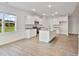 Bright, open kitchen features white cabinets, granite counters, stainless appliances, and center island at 32 Boyce Ct, Sanford, NC 27332