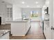 Kitchen with stainless steel appliances, granite counters, white cabinets, and wainscotting in dining area at 32 Boyce Ct, Sanford, NC 27332