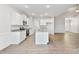 Bright, open kitchen with white cabinets, granite counters, stainless appliances, and kitchen island at 32 Boyce Ct, Sanford, NC 27332