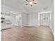 Open-concept kitchen and living room featuring white cabinets, granite countertops, and modern flooring at 32 Boyce Ct, Sanford, NC 27332