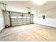 A clean, empty two car garage with an automatic door opener, ready for parking and storage at 335 Bishop Ln, Sanford, NC 27330