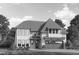 Elegant two-story home featuring a spacious two-car garage, large windows, and lush landscaping at 416 Englewood Dr, Chapel Hill, NC 27514