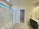 Bathroom with a large walk-in glass shower, a tiled floor, and a view to the walk-in closet at 225 Bering Cir, Angier, NC 27501