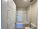 Bathroom featuring a shower-tub combination and tiled walls at 225 Bering Cir, Angier, NC 27501