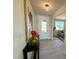 Bright foyer featuring wood-look floors, stylish lighting, and front door view to the exterior at 225 Bering Cir, Angier, NC 27501