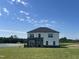 Beautiful two-story home with stone and white siding accents and a well-manicured lawn at 225 Bering Cir, Angier, NC 27501