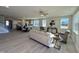 Open-concept living space with hardwood floors, lots of natural light, and modern furnishings at 225 Bering Cir, Angier, NC 27501