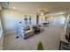 Neutral living room featuring gray sofas, accent tables, and a ceiling fan at 225 Bering Cir, Angier, NC 27501