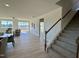 Living room and staircase with an open floor plan and sliding door to the back porch at 225 Bering Cir, Angier, NC 27501