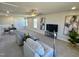 Bright living room features two sofas, modern decor, neutral walls, and a ceiling fan at 225 Bering Cir, Angier, NC 27501