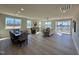 Open-concept living and dining area with plenty of natural light and access to a screened porch at 225 Bering Cir, Angier, NC 27501