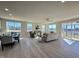 Open-concept living space with hardwood floors, lots of natural light, and sliding door to the back porch at 225 Bering Cir, Angier, NC 27501