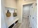 Convenient mud room with bench, storage, and hooks, located near the laundry room at 225 Bering Cir, Angier, NC 27501