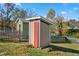 Backyard sheds with orange doors, perfect for storage and hobbies with an enclosed fence at 2416 Glencoe St, Burlington, NC 27217