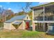 A cute barn with an orange door in the backyard with a fenced in area at 2416 Glencoe St, Burlington, NC 27217