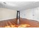 Spacious bedroom featuring hardwood floors, white paneled walls and ceiling, plus ample closet space at 2416 Glencoe St, Burlington, NC 27217