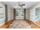 Spacious bedroom featuring hardwood floors, overhead fan, and ample natural light from two windows at 2416 Glencoe St, Burlington, NC 27217