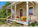 Inviting front porch showcasing plants, railing, and charming details at 2416 Glencoe St, Burlington, NC 27217