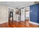Hallway with hardwood floors features multiple doorways leading to bedrooms and bathrooms at 2416 Glencoe St, Burlington, NC 27217