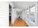 Bright hallway with windows, hardwood floors, and white walls at 2416 Glencoe St, Burlington, NC 27217