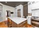Modern kitchen with island seating, stainless steel appliances, and white cabinets at 2416 Glencoe St, Burlington, NC 27217