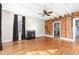Bright living room with hardwood floors, a fireplace, and exposed brick at 2416 Glencoe St, Burlington, NC 27217