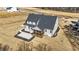 Aerial view of a two-story home showcasing the backyard, screened porch, and patio at 25 Firefly Ln, Youngsville, NC 27596