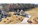 Aerial view of two-story gray and white home, showcasing the driveway, roof, and front yard at 25 Firefly Ln, Youngsville, NC 27596