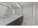 Bathroom with double sink vanity, quartz countertop, and modern lighting fixtures at 25 Firefly Ln, Youngsville, NC 27596
