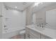 Bright bathroom features a vanity with a large mirror, a shower-tub combo, and neutral walls at 25 Firefly Ln, Youngsville, NC 27596